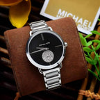 Michael Kors Portia MK3638 silver-tone watch with black dial on a brown display pillow