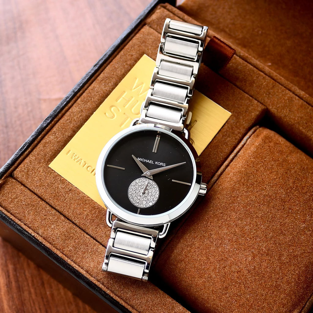 Michael Kors Portia MK3638 silver-tone watch arranged on a brown presentation box