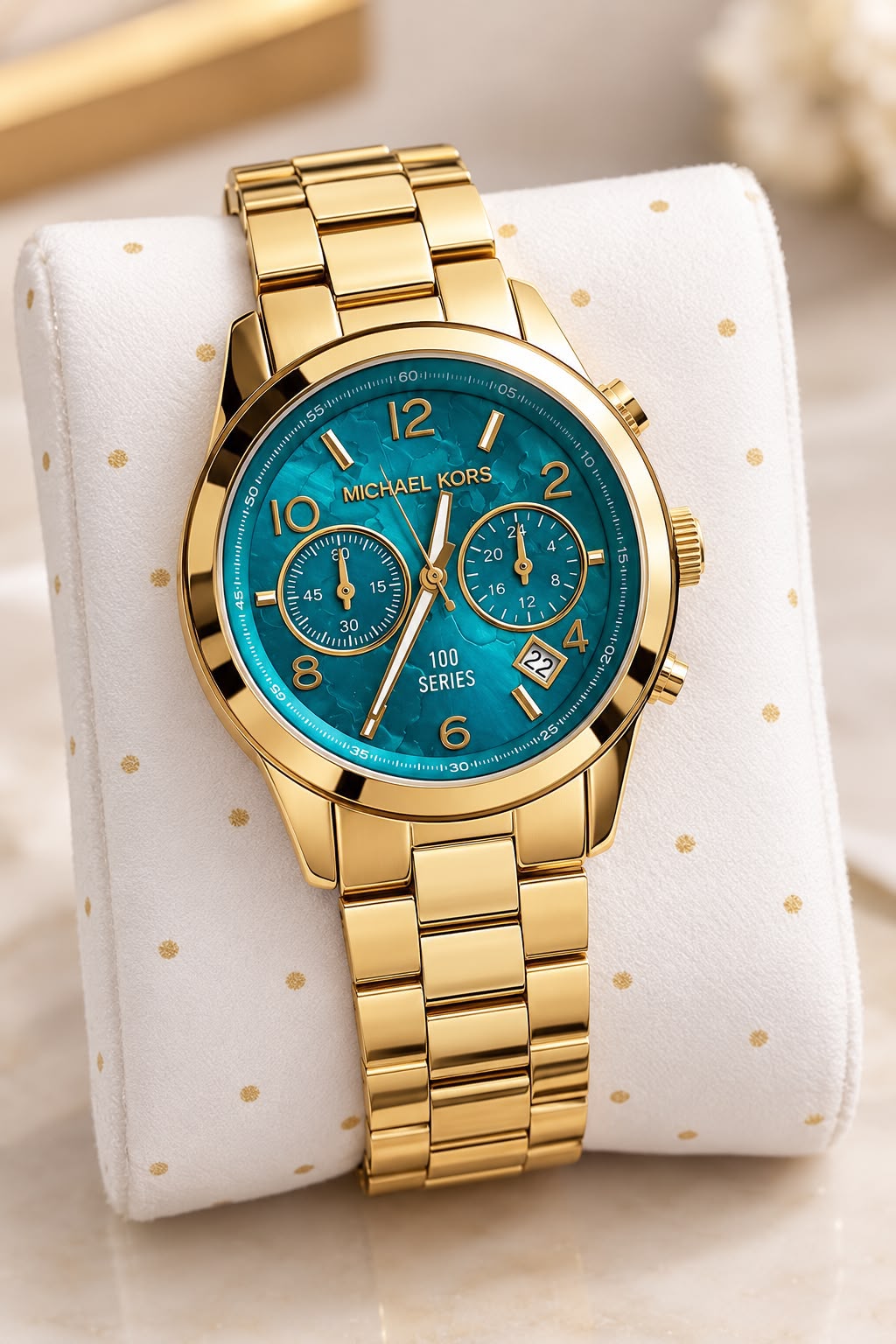 Michael Kors MK5815 gold-tone watch on a white display pillow