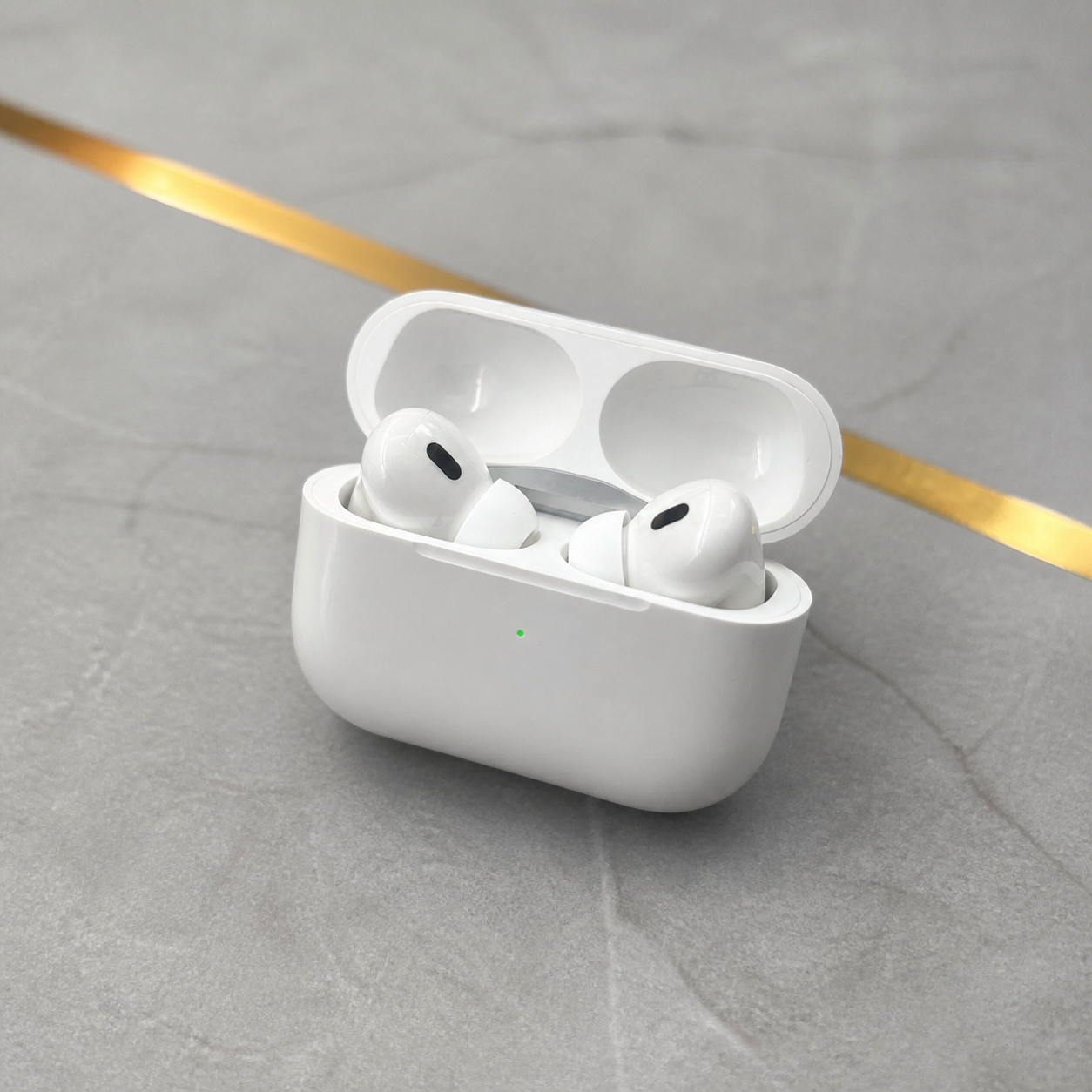 PrimePicks white wireless earbuds in open case with green indicator, elevated view