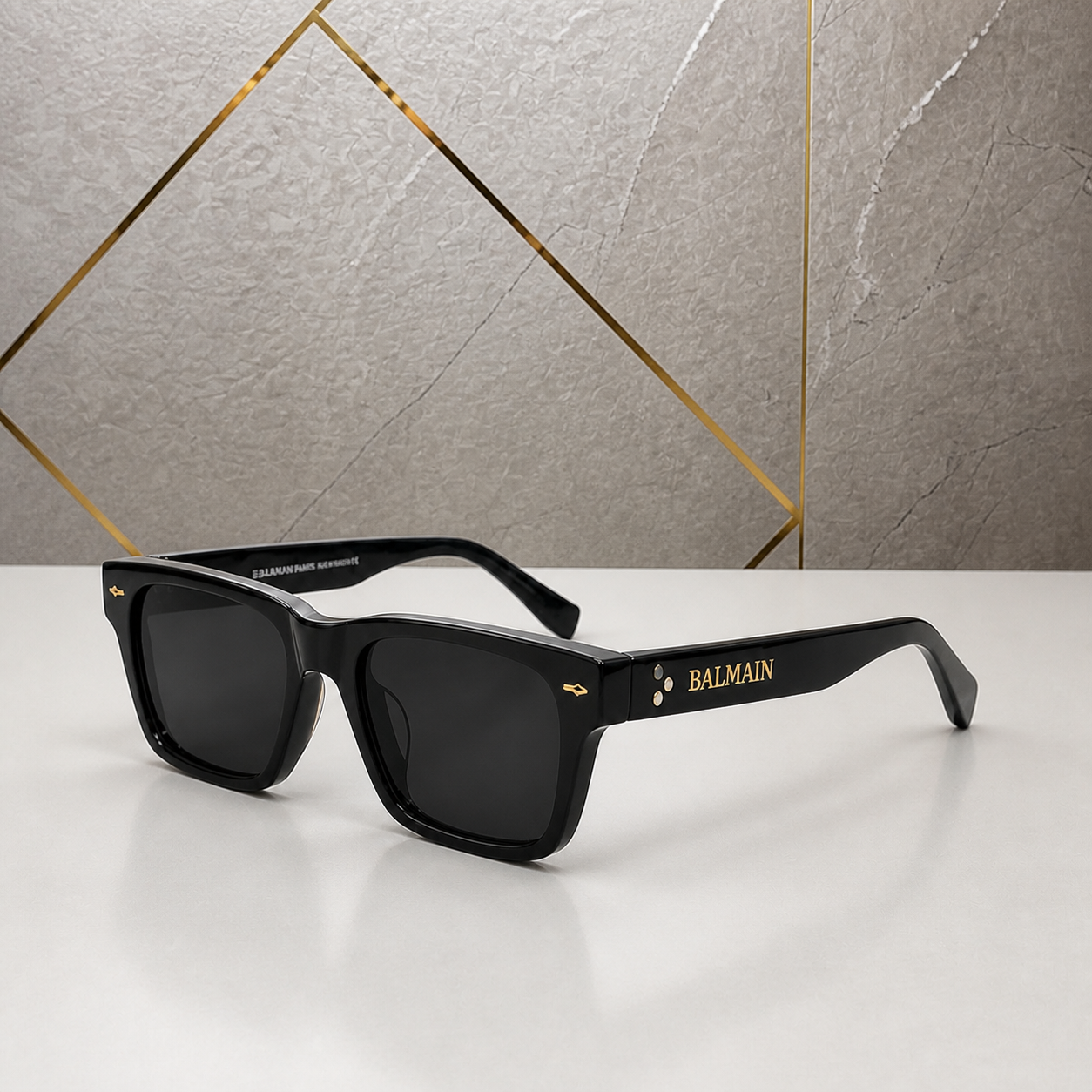 Balmain black sunglasses alternate three-quarter view against grey stone wall