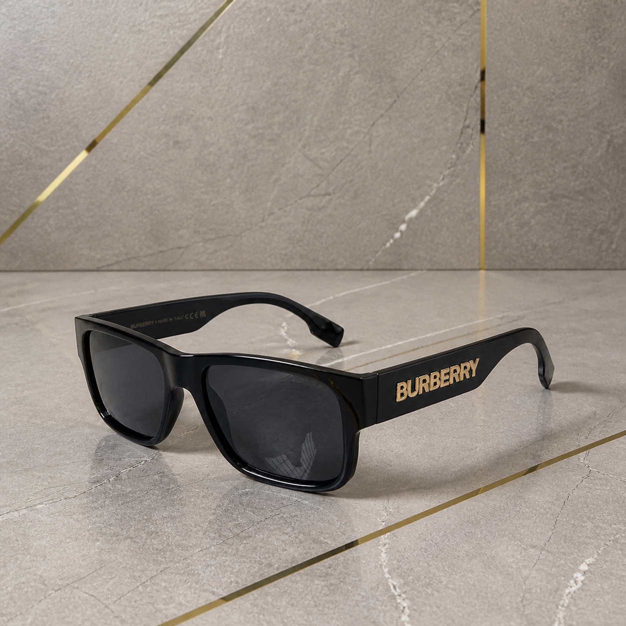 Burberry black sunglasses in an alternate view against the grey office wall