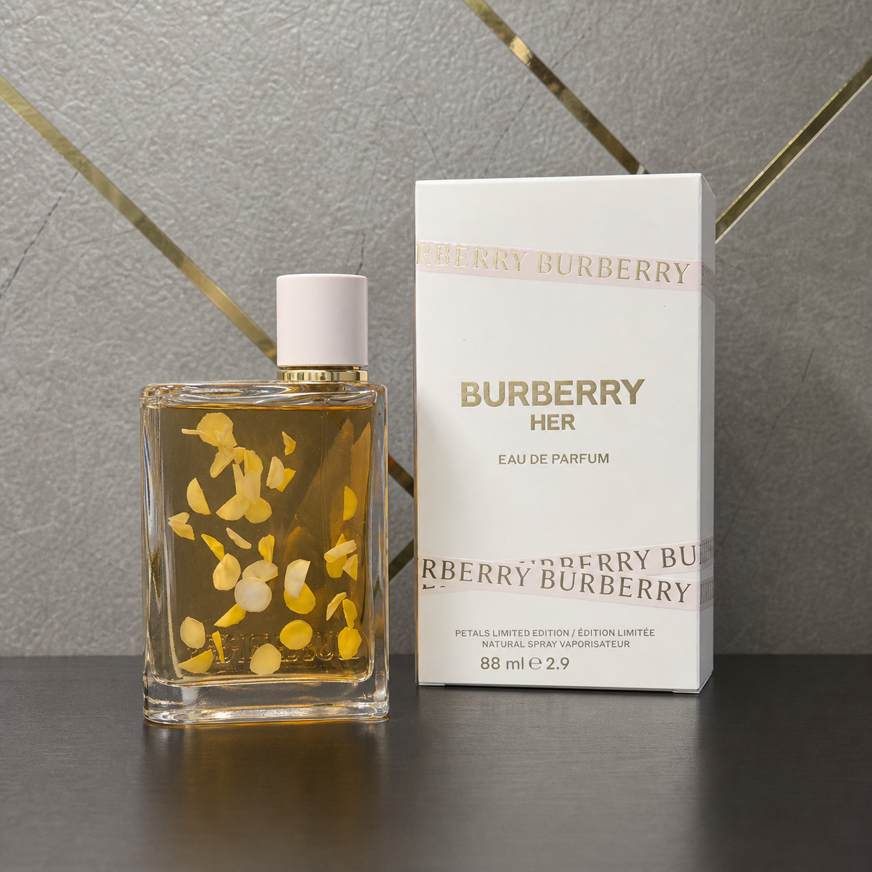 Burberry Her Petals Limited Edition perfume and box against the grey and gold office wall