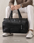 Calvin Klein black duffle bag shown with a model