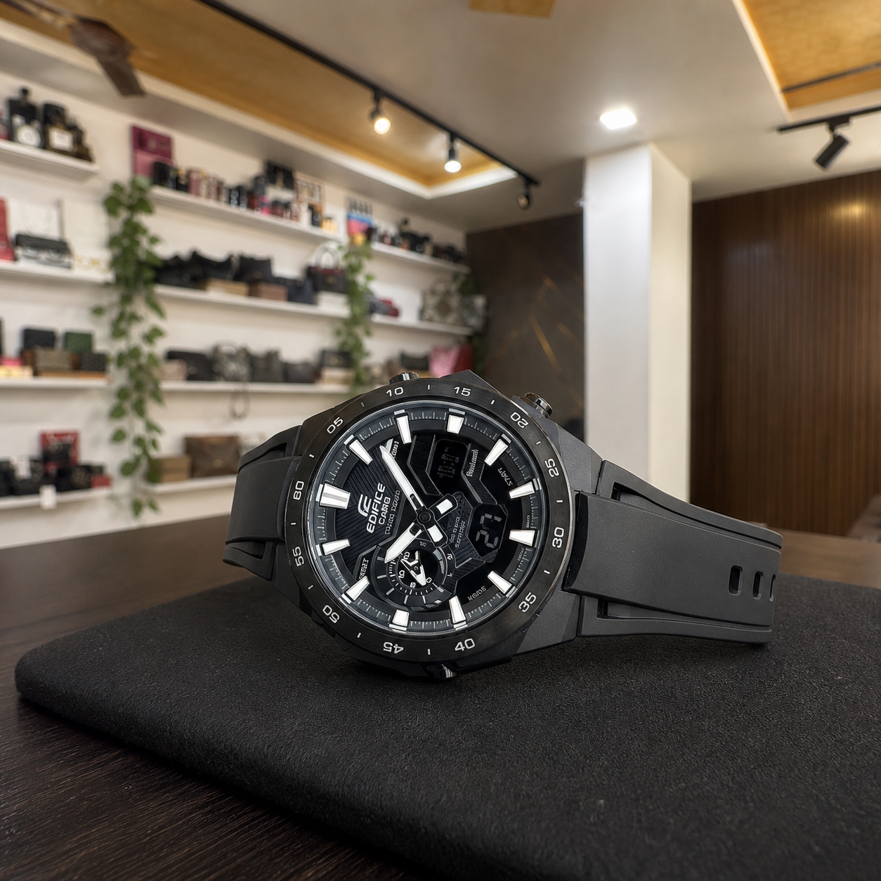 Horizontal view of Casio Edifice ECB-2200PB-1A black watch on a display pad in the Primepicks office