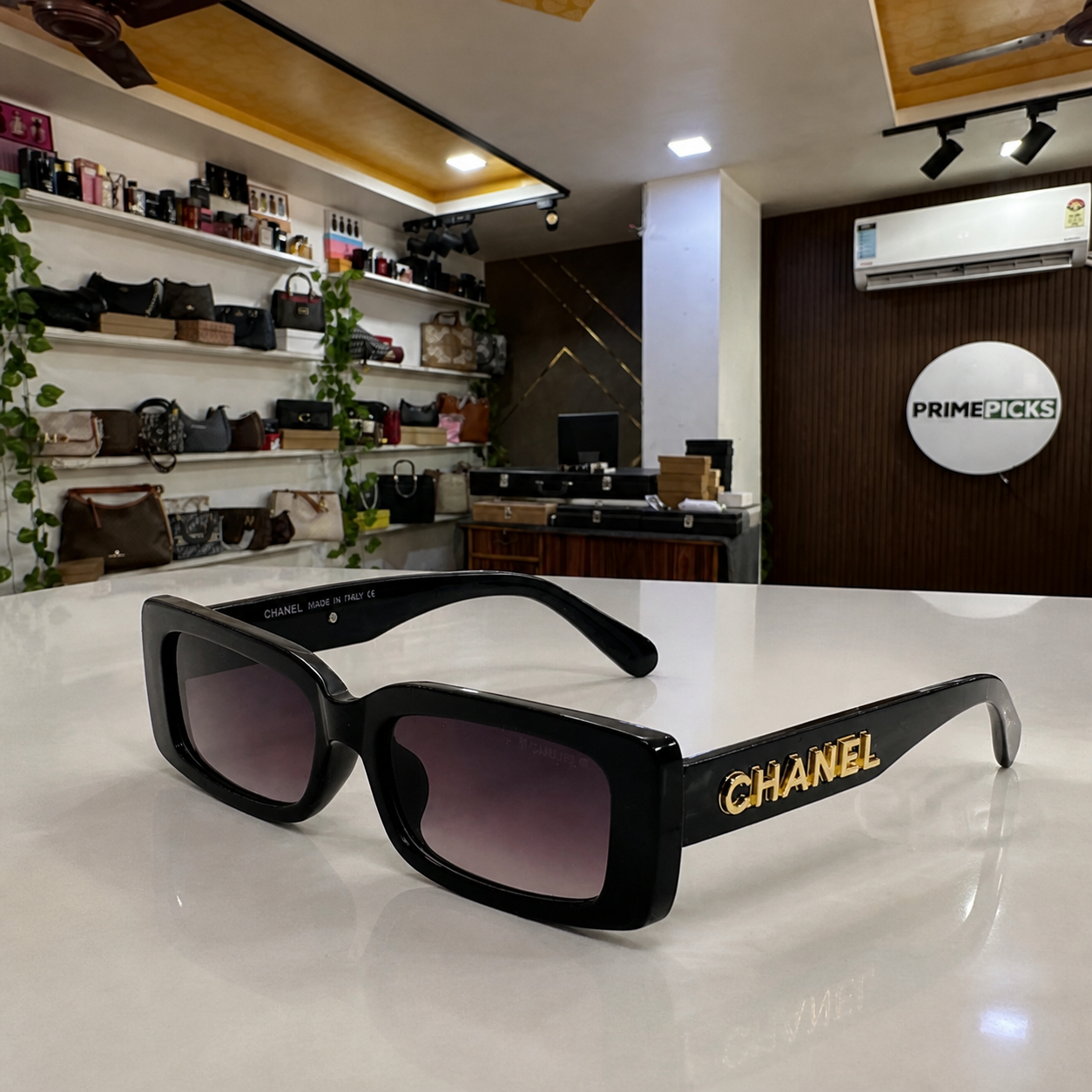 Chanel black rectangular gradient sunglasses office lifestyle view at PrimePicks