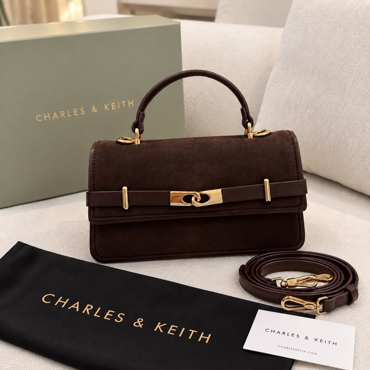 Brown Charles & Keith Arlet bag front view with shoulder strap and dustcover