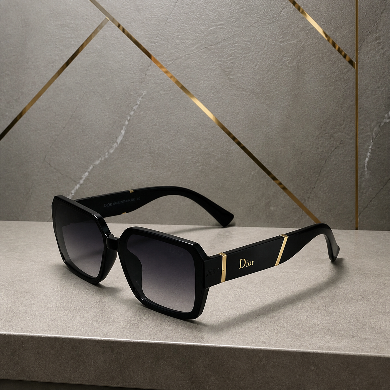 Dior black geometric gradient sunglasses alternate angle against grey office wall