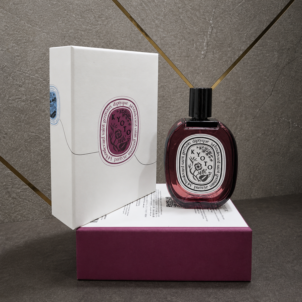 Diptyque Kyoto perfume with presentation packaging on stone and gold office wall