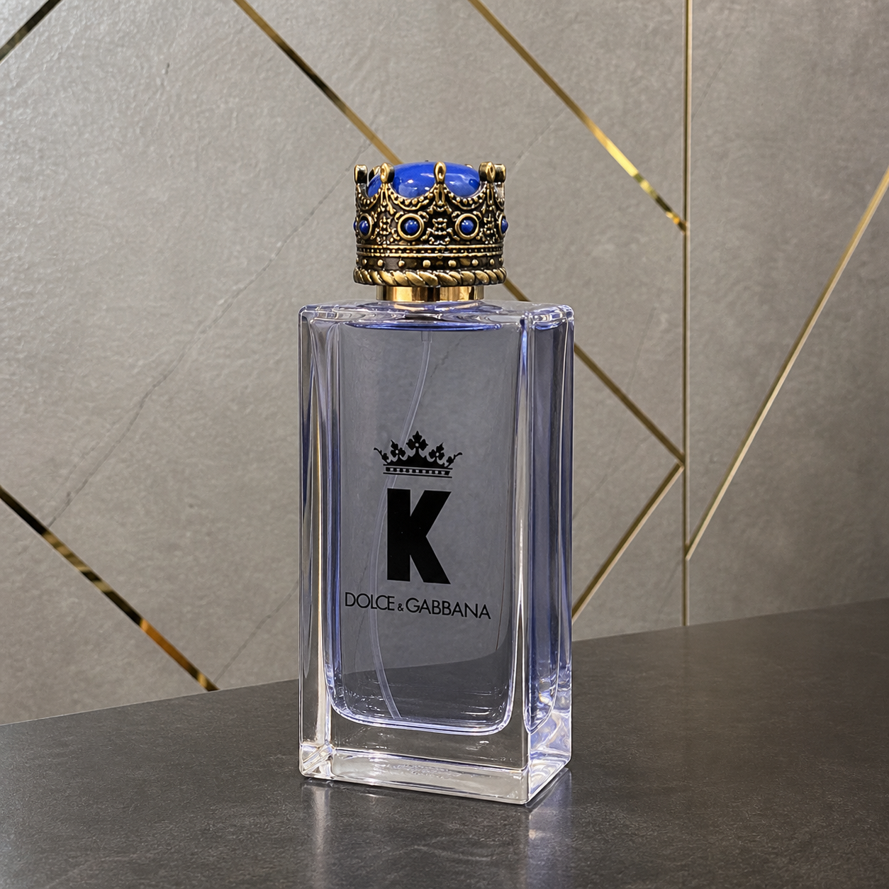 Dolce & Gabbana K bottle against the PrimePicks stone wall
