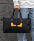 Fendi Ikonik 2.0 large black duffel bag carried by a model
