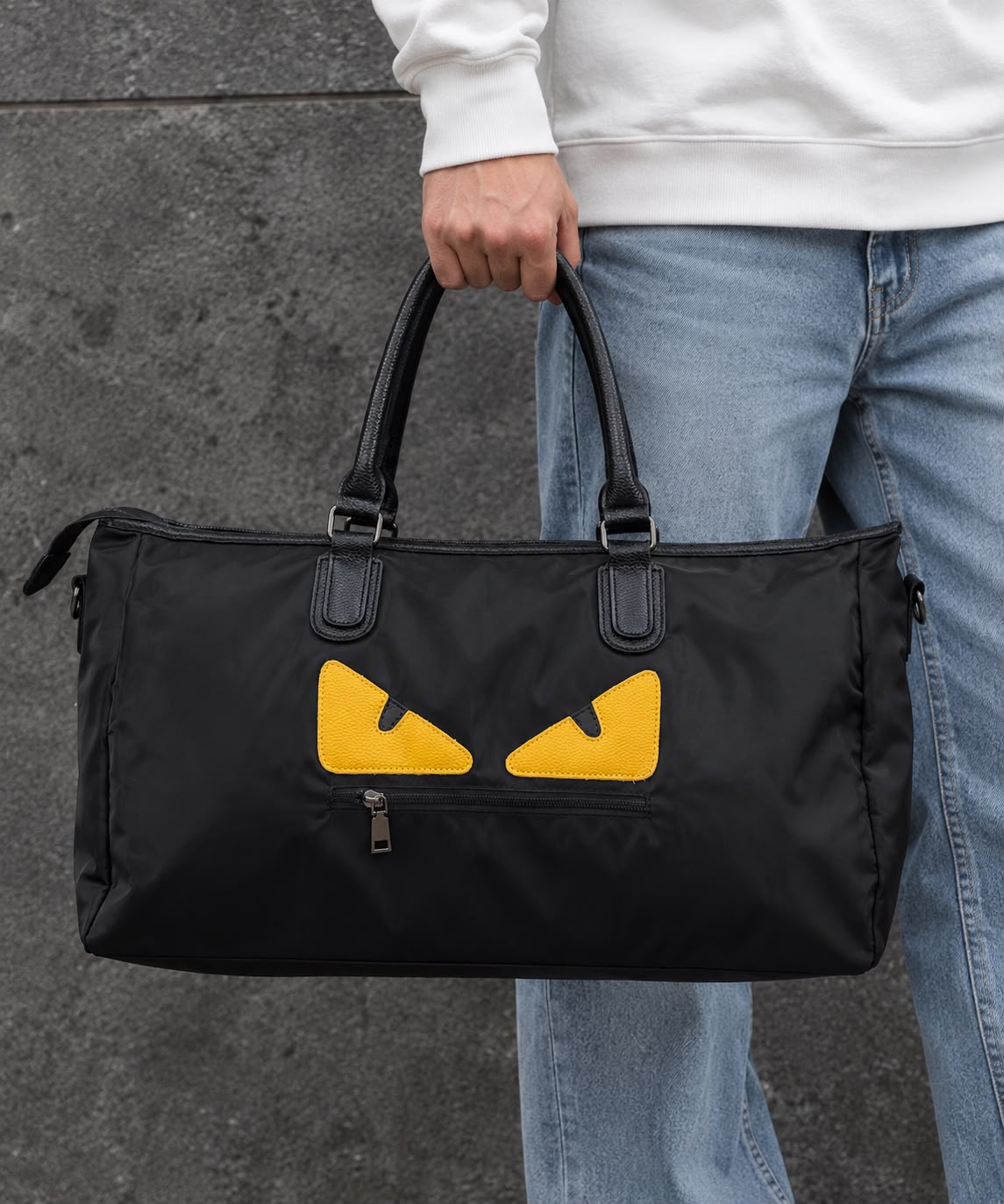 Fendi Ikonik 2.0 large black duffel bag carried by a model