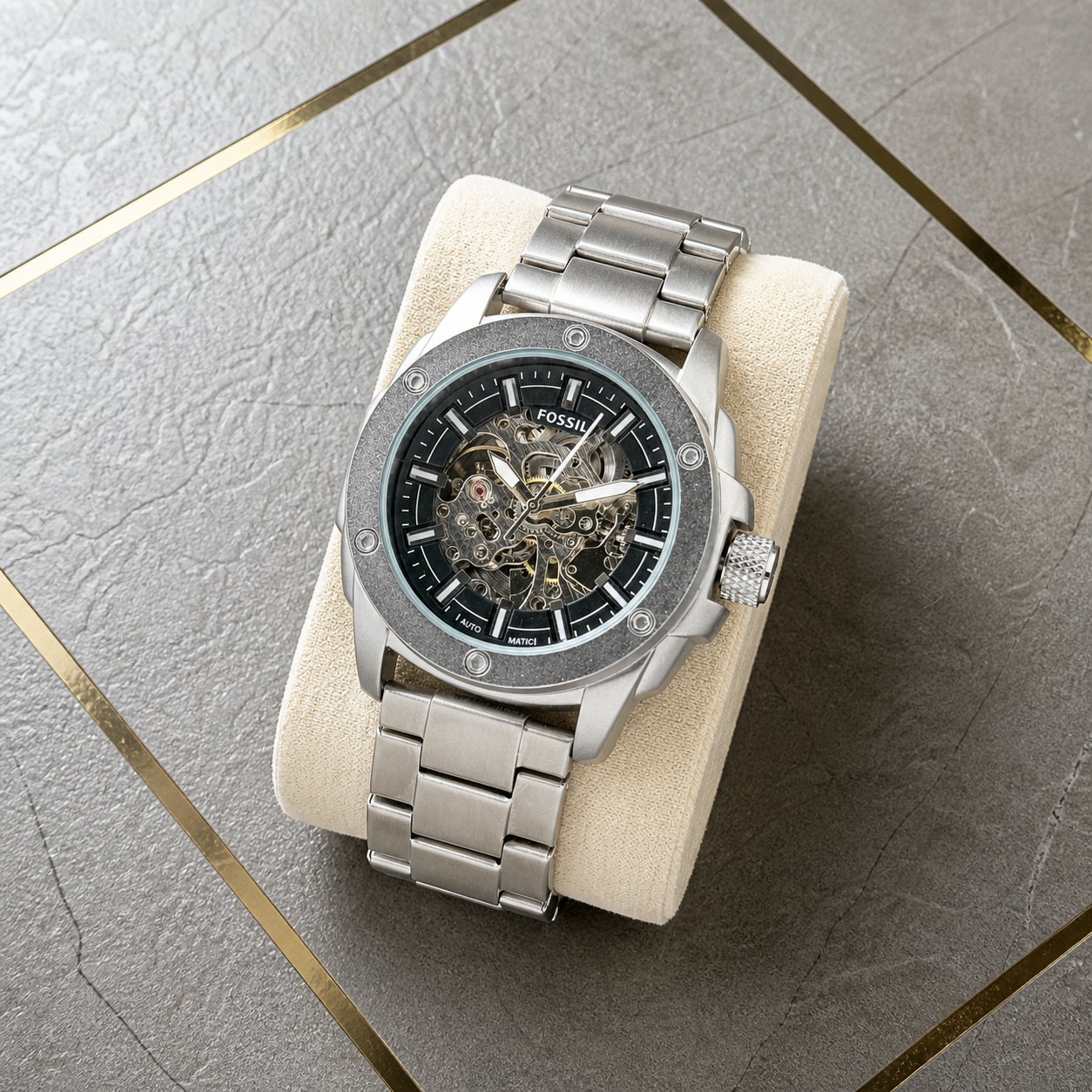 Fossil Modern Machine automatic skeleton men's watch flat lay at the Primepicks grey and gold office wall