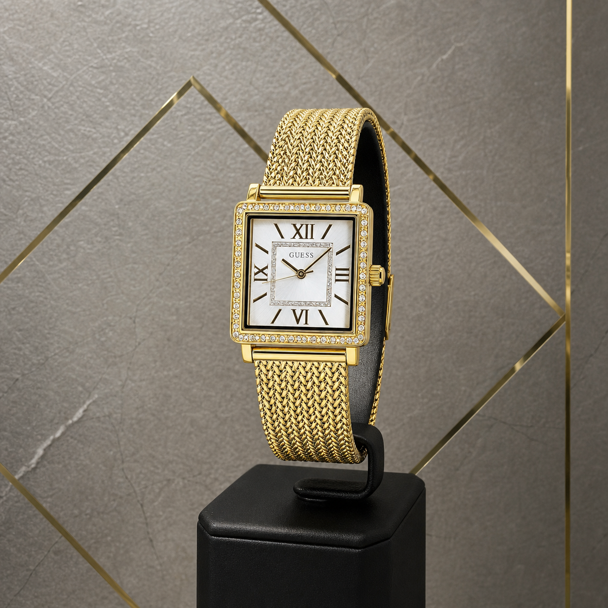 Guess Classic gold square women's watch against grey and gold office wall