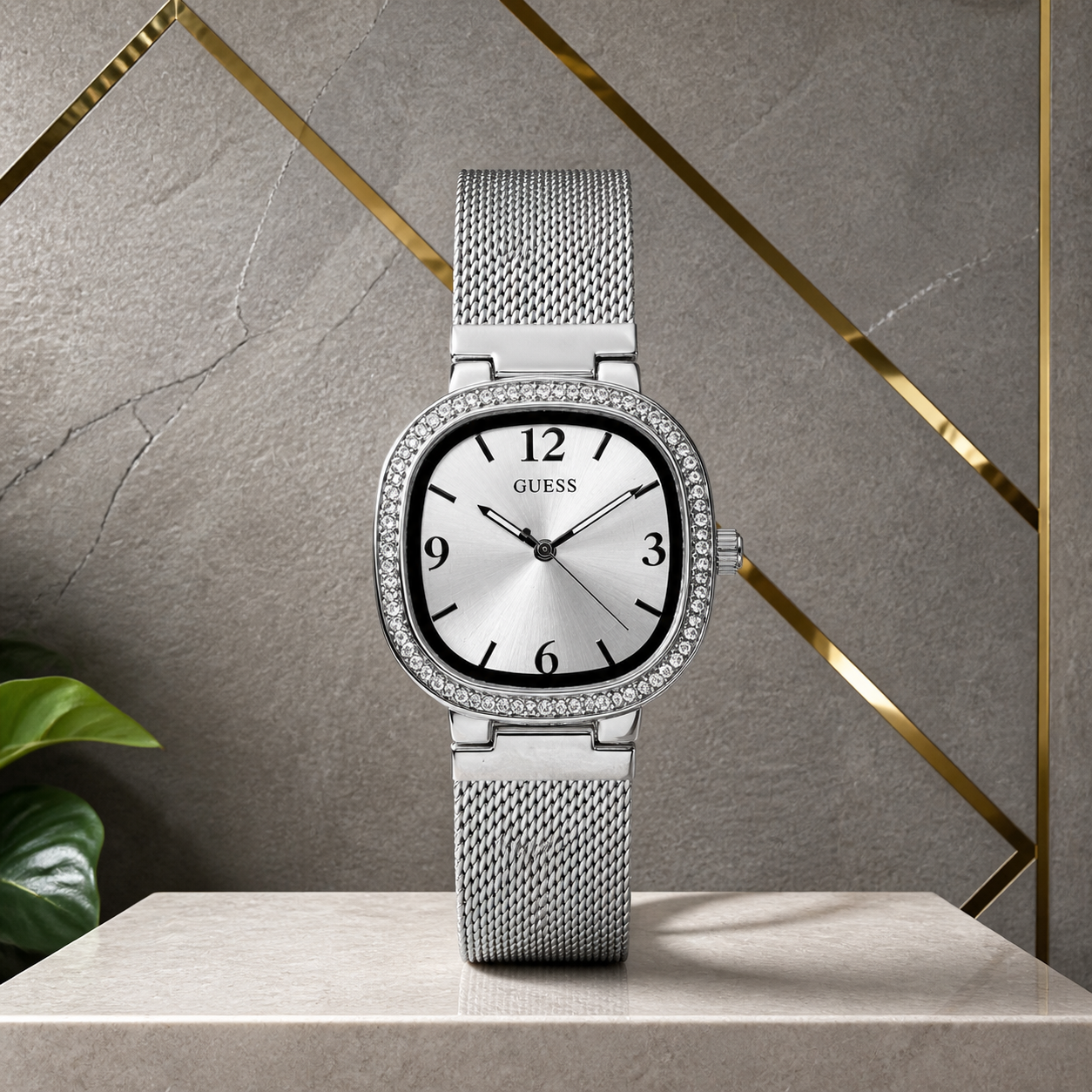 Guess Tapestry silver women’s watch on grey and gold office wall