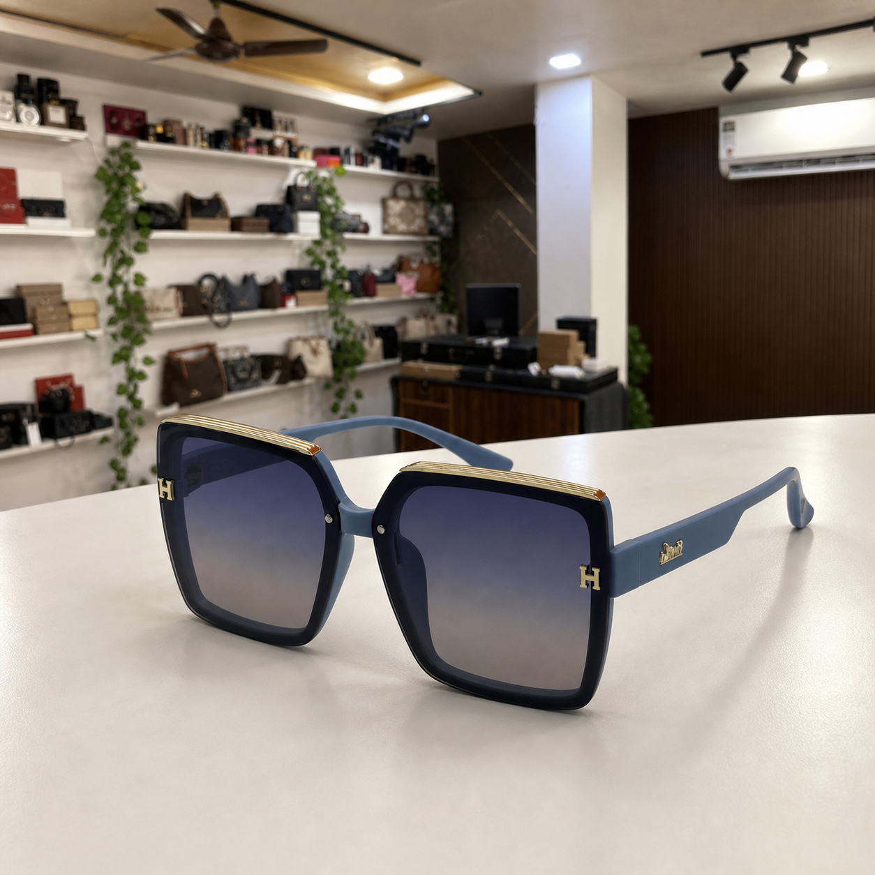 Hermes oversized square sunglasses in slate blue, PrimePicks office display