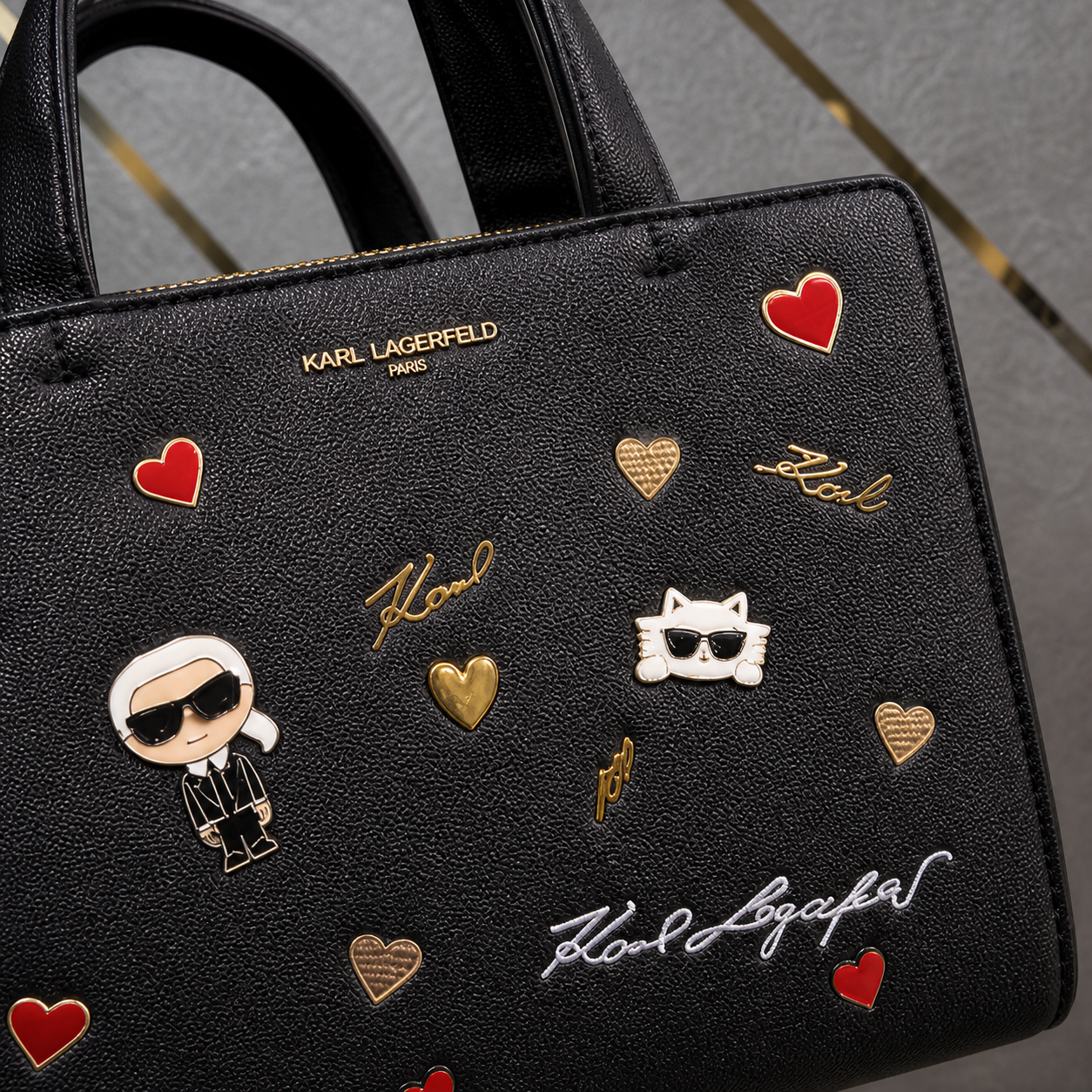 Karl Lagerfeld Paris Maybelle Satchel character and heart pin detail
