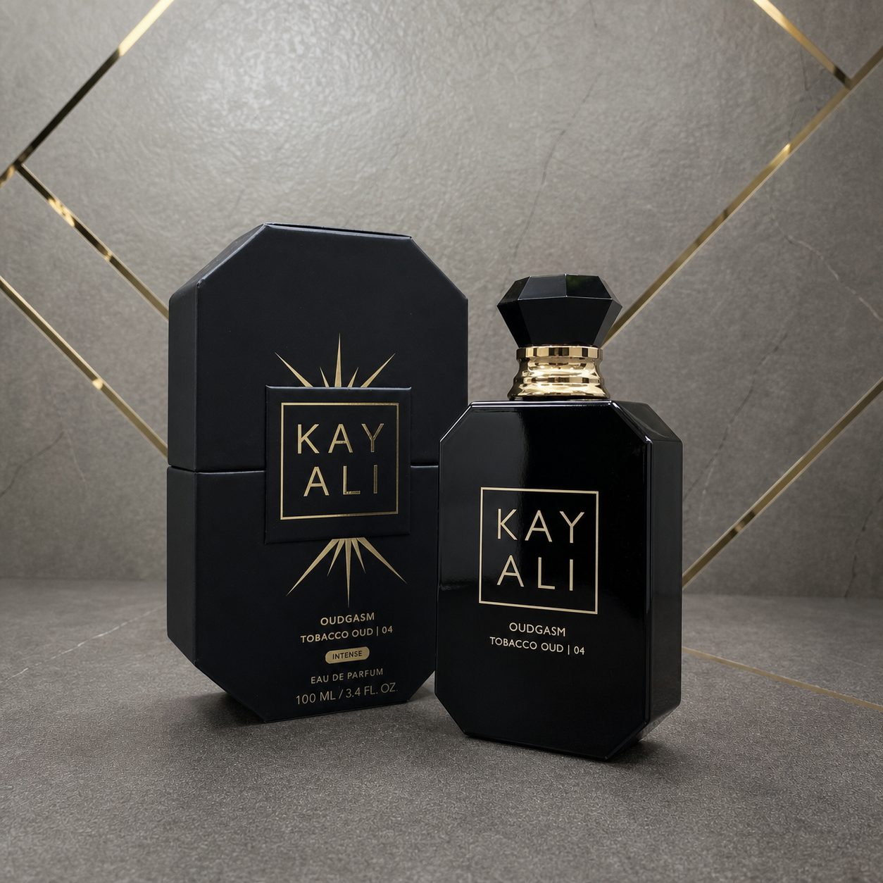 Kayali Oudgasm Tobacco Oud | 04 Intense Eau de Parfum 100ml with box on stone and gold office wall