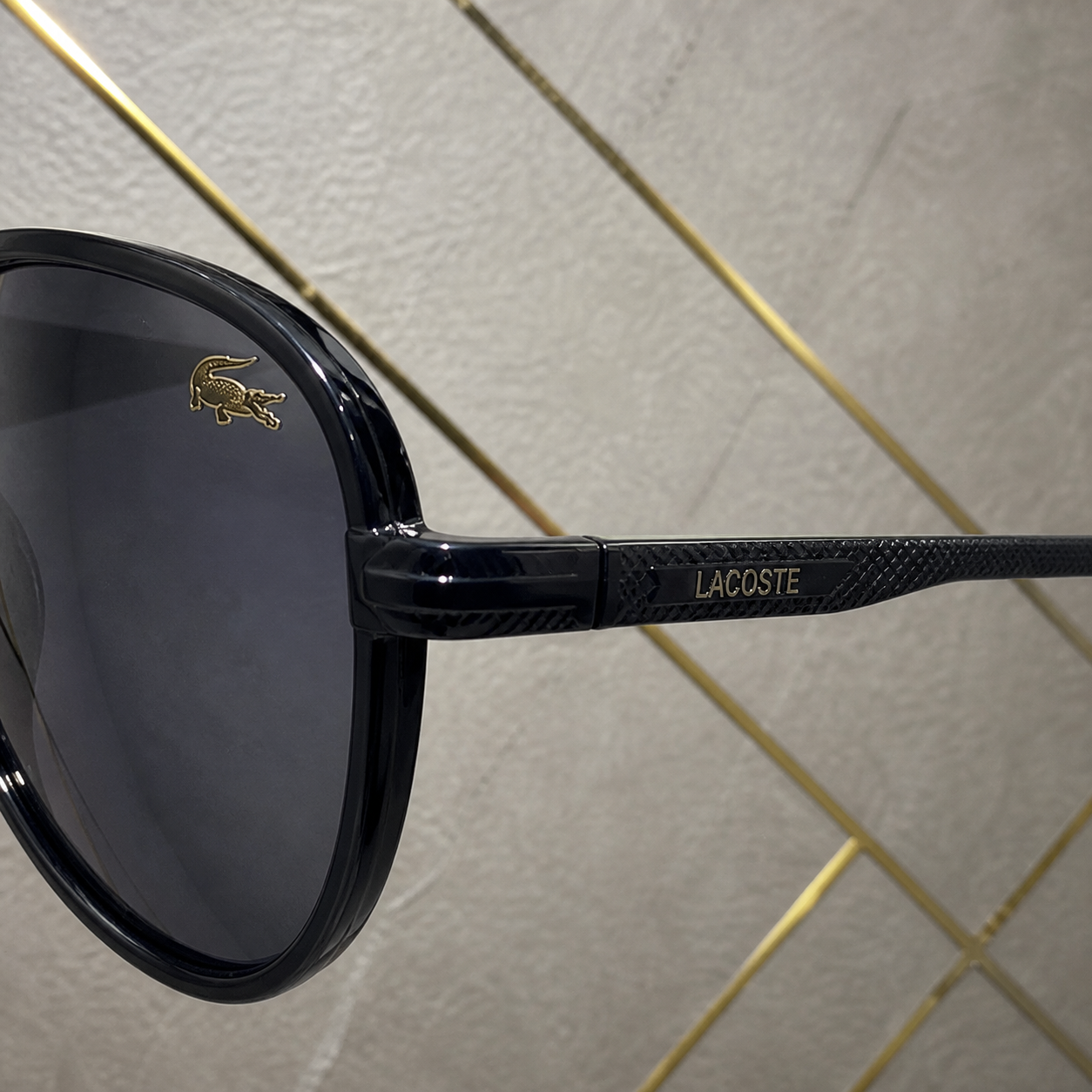 Lacoste sunglasses textured black temple and lens accent detail