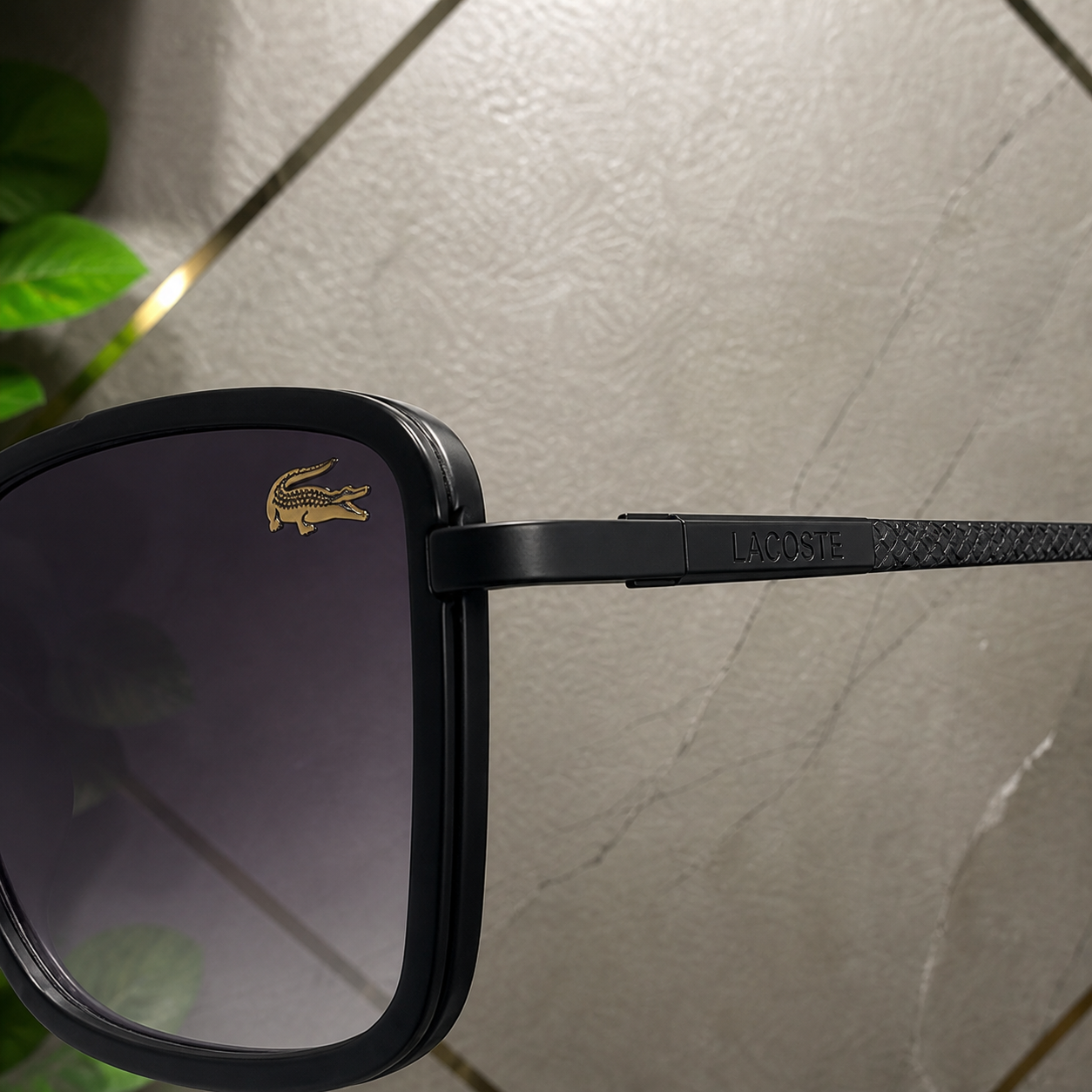 Lacoste sunglasses black textured temple and gold-tone lens accent detail