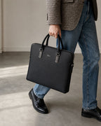 Black Lacoste laptop bag carried with smart casual attire
