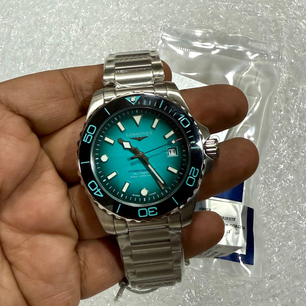 Longines HydroConquest turquoise dial watch handheld front view