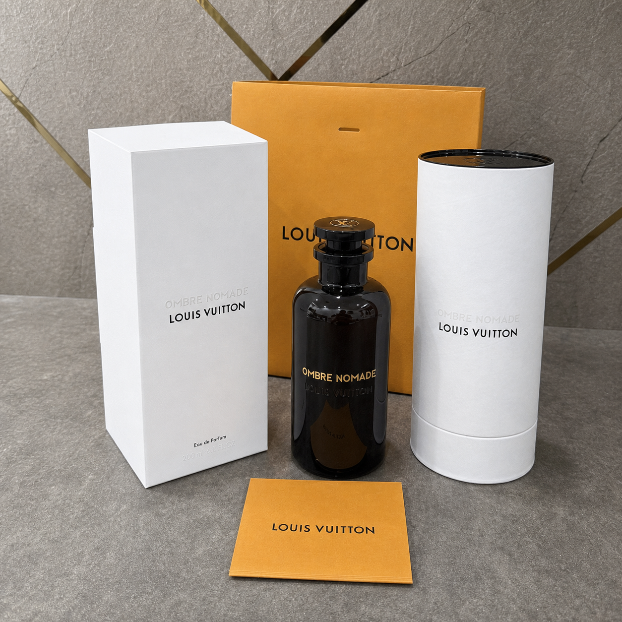 Louis Vuitton Ombré Nomade Eau de Parfum 200ml against the PrimePicks grey stone and gold wall