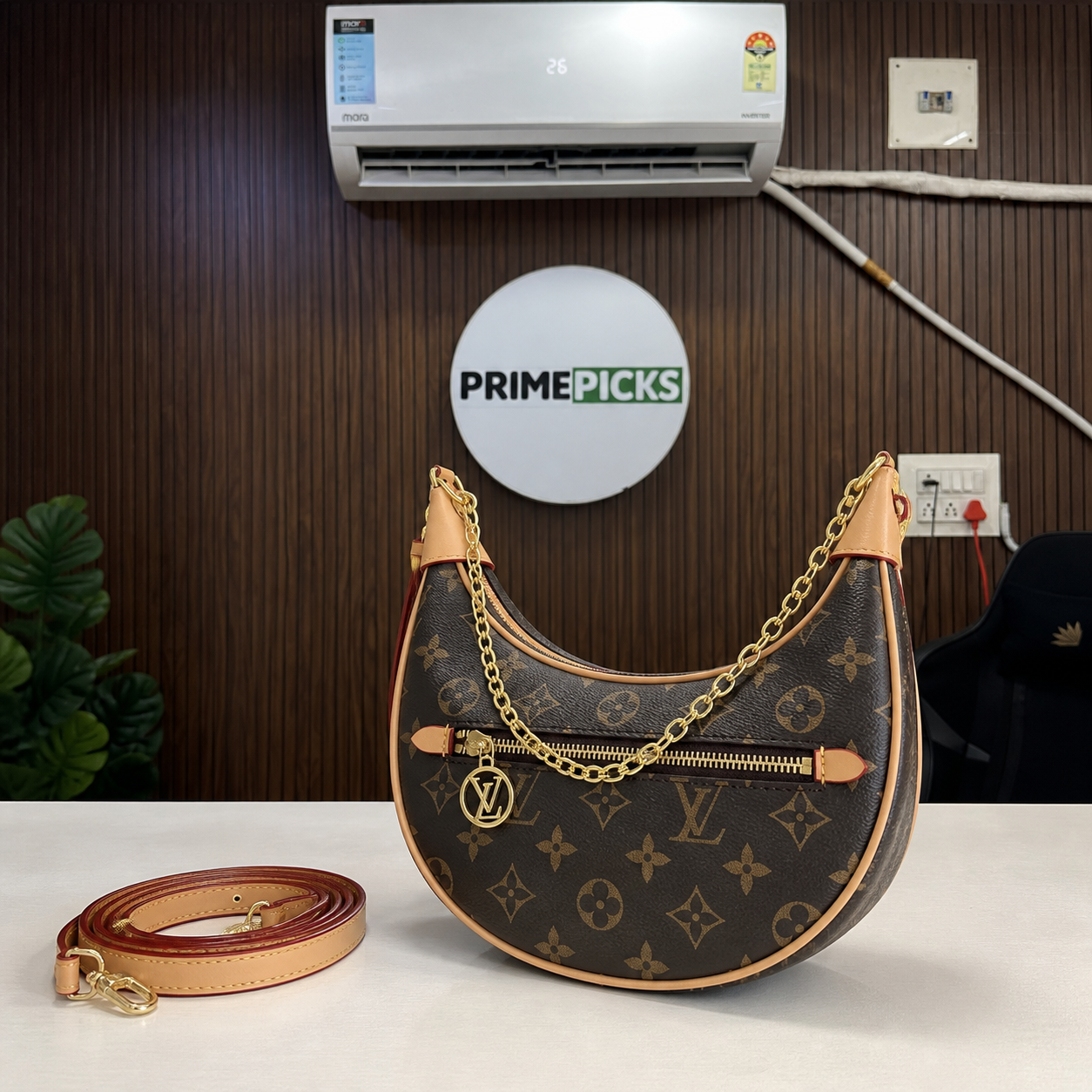 Louis Vuitton Loop brown monogram handbag on walnut office backdrop