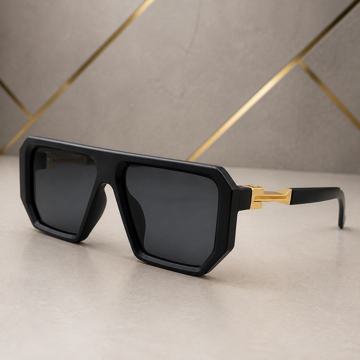 Marc Jacobs matte black angular square sunglasses with gold-tone hinges and dark smoke lenses, alternate three-quarter view