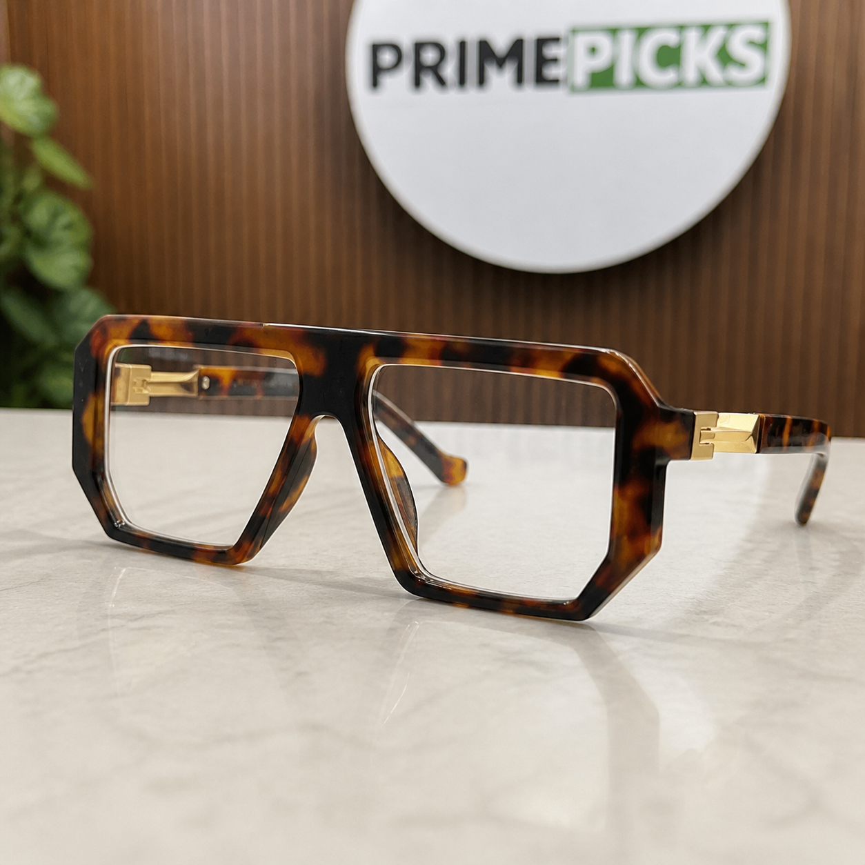 Marc Jacobs tortoiseshell angular square glasses with gold-tone hinges and clear lenses, front three-quarter hero view