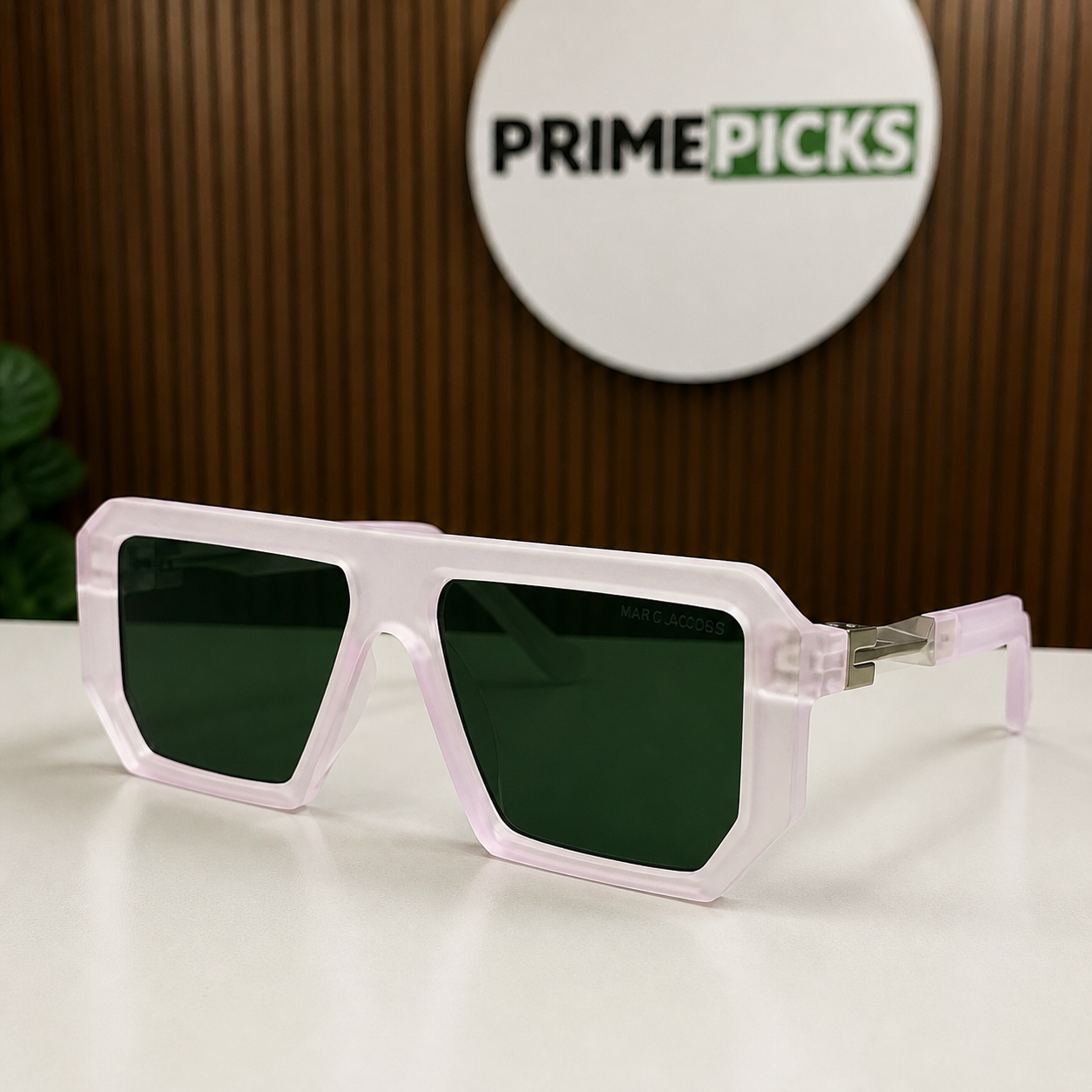 Marc Jacobs translucent blush angular square sunglasses with silver-tone hinges and dark green lenses, front three-quarter hero view