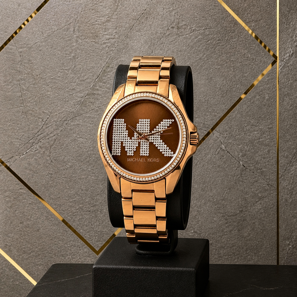 Michael Kors Bradshaw rose-gold MK crystal watch on gray and gold office wall