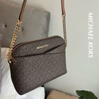 Michael Kors Jet Set Travel dome crossbody bag in Brown Signature lifestyle view