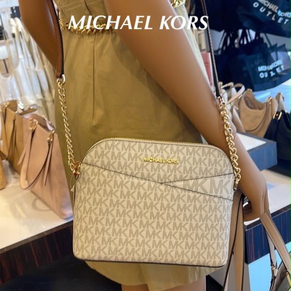 Michael Kors Jet Set Travel dome crossbody bag in Vanilla Signature lifestyle view