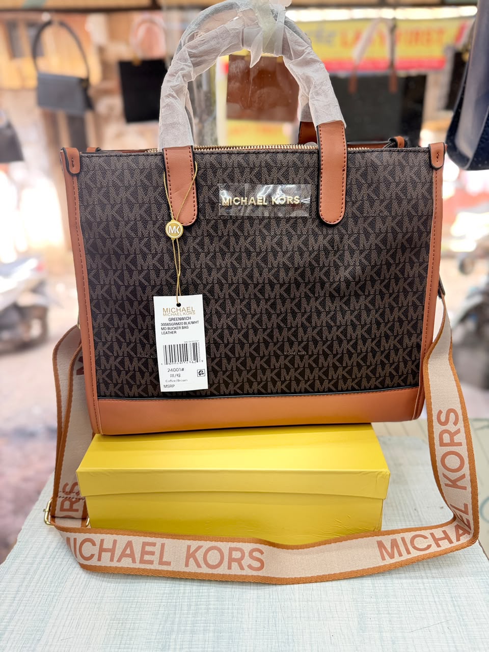 Michael Kors Mini Tote Brown Signature front view with branded strap