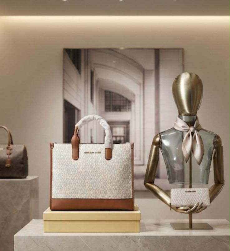 Michael Kors Mini Tote in Vanilla Signature displayed with included box