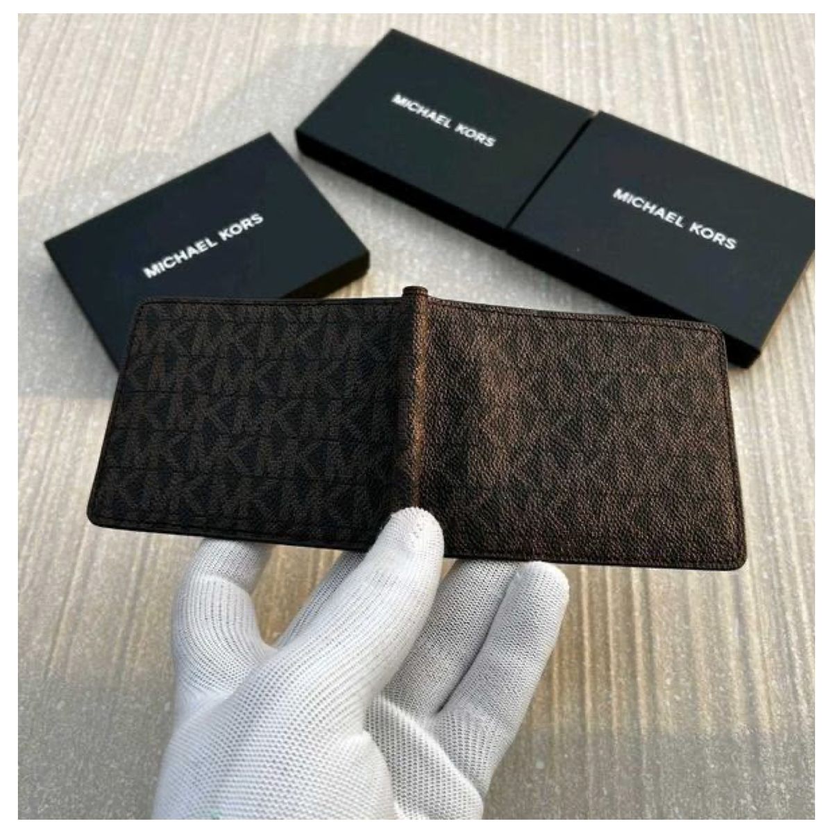 Open Michael Kors bifold wallet showing its interior with the included MK box
