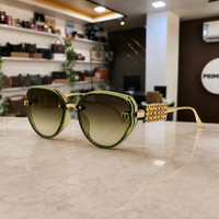 Miu Miu jeweled hinge sunglasses in translucent olive green, hero view