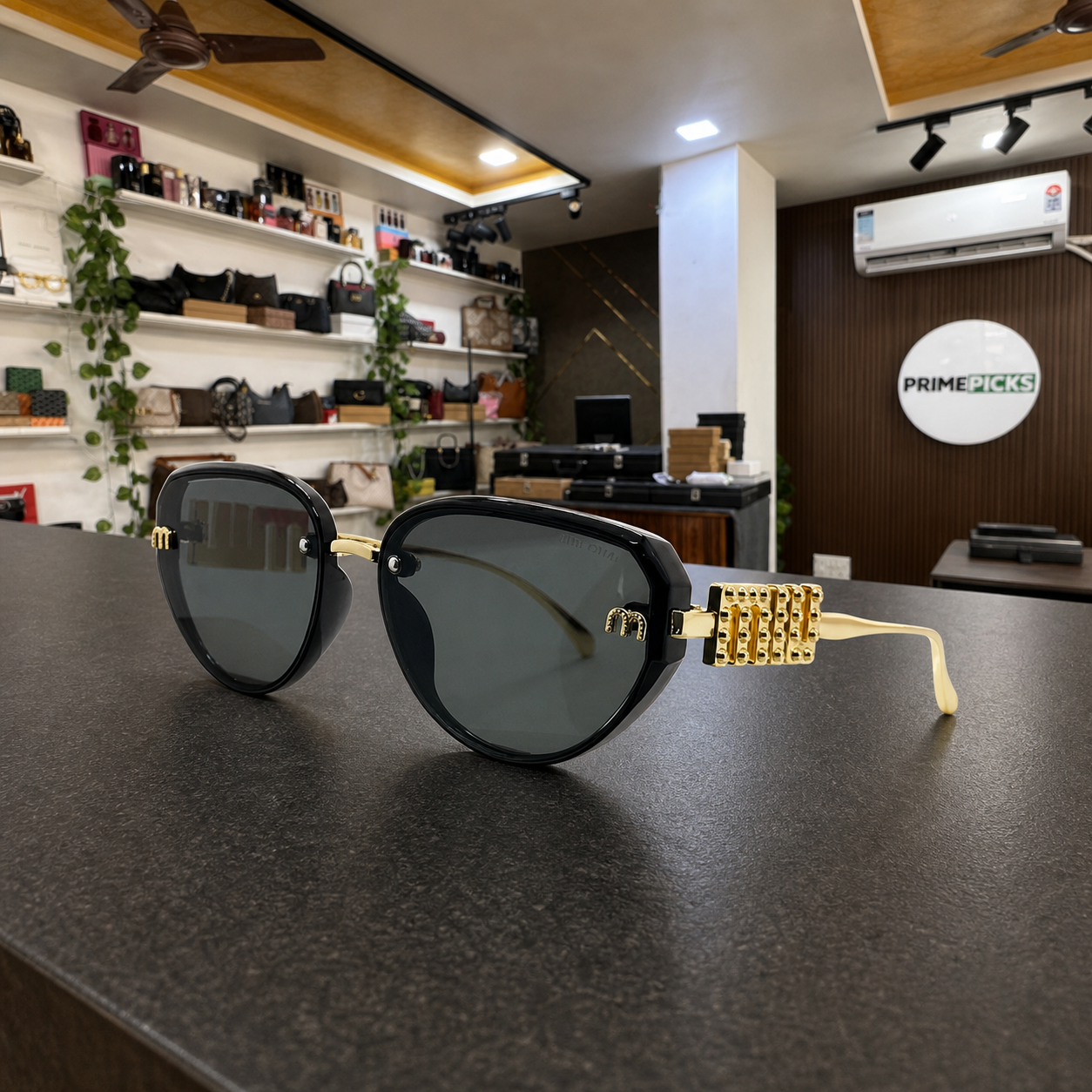 Miu Miu jeweled hinge sunglasses in glossy black, PrimePicks office display