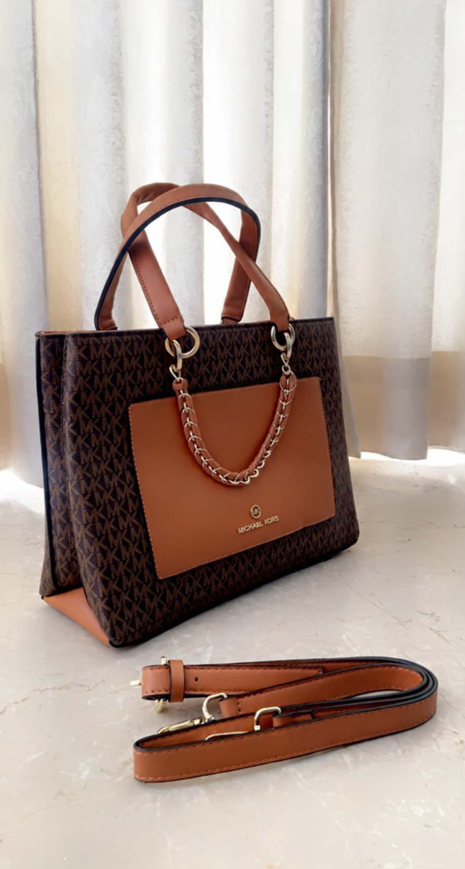 Michael Kors Cece Mono Brown Signature handbag angled view with long belt