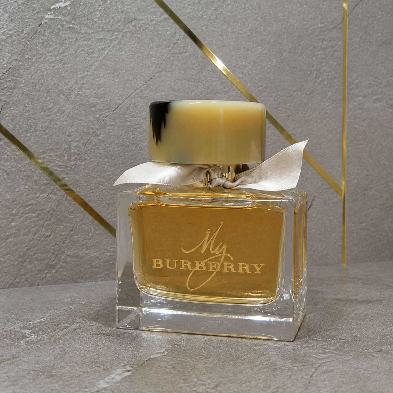 My Burberry Eau de Parfum 90ml bottle against the PrimePicks stone wall