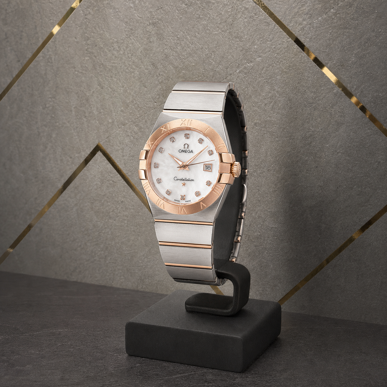 Omega Constellation white-dial watch against the grey and gold Primepicks office wall
