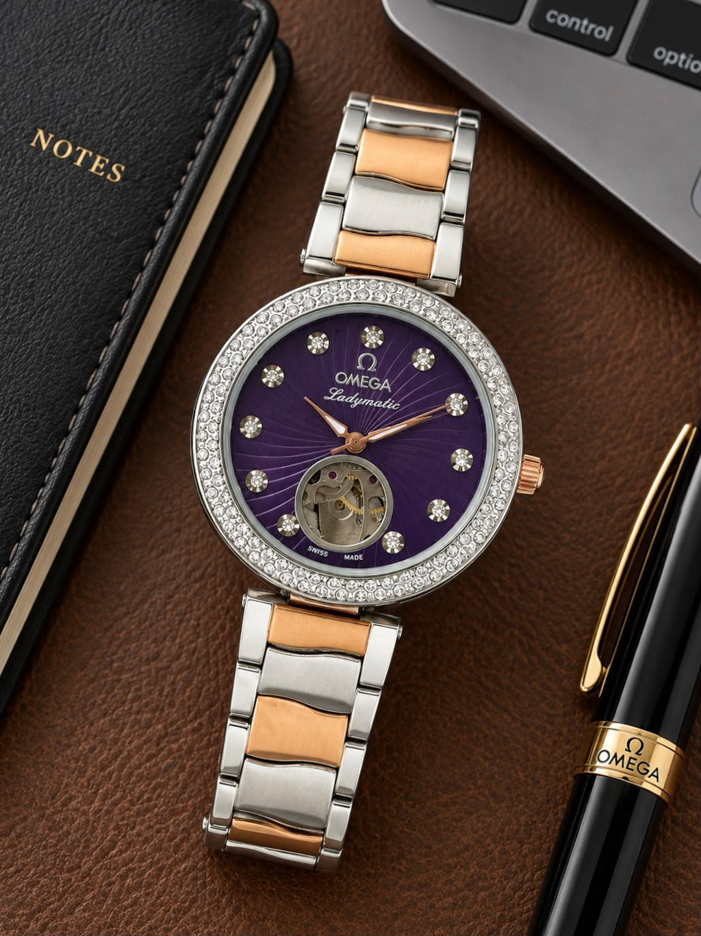 Omega Ladymatic purple dial open-heart watch arranged on a desk