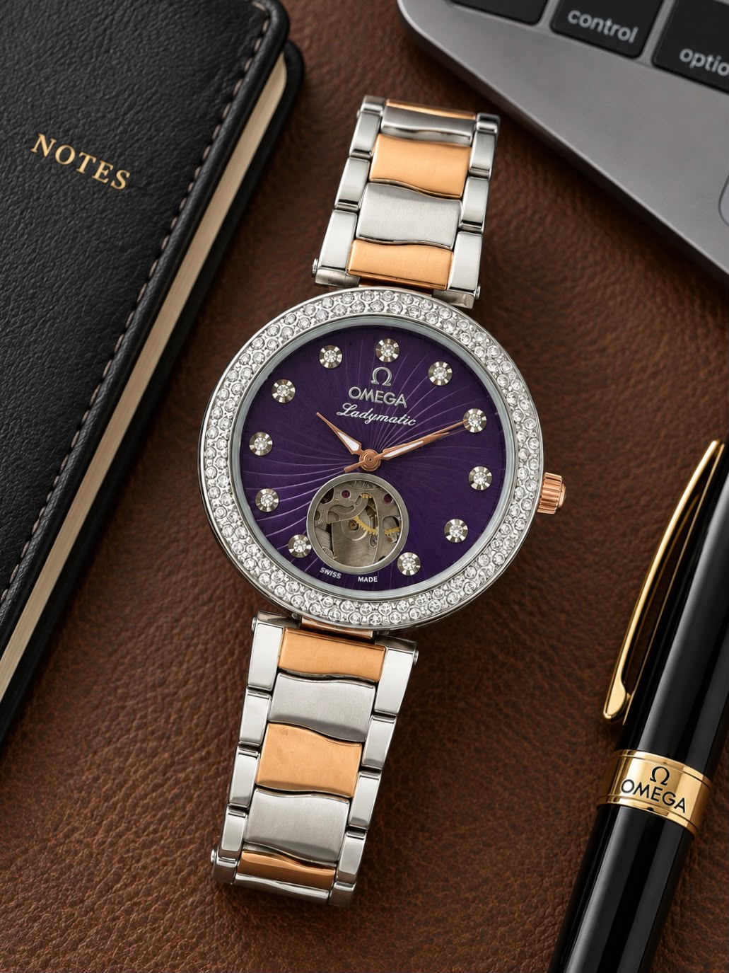 Omega Ladymatic purple dial open-heart watch arranged on a desk