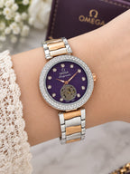 Omega Ladymatic purple dial two-tone watch worn on the wrist
