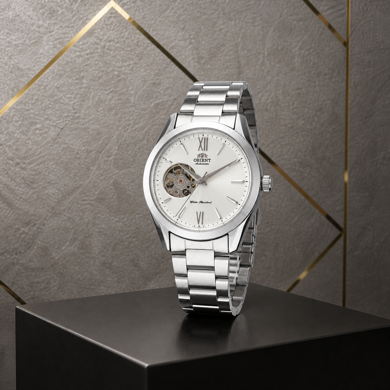 Orient open-heart automatic men’s watch with steel bracelet against the grey and gold Primepicks office wall