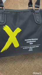 Supplier video of the black duffel bag with yellow graphic