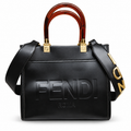 Fendi-marked black tote with amber-brown handles; edited white-background image