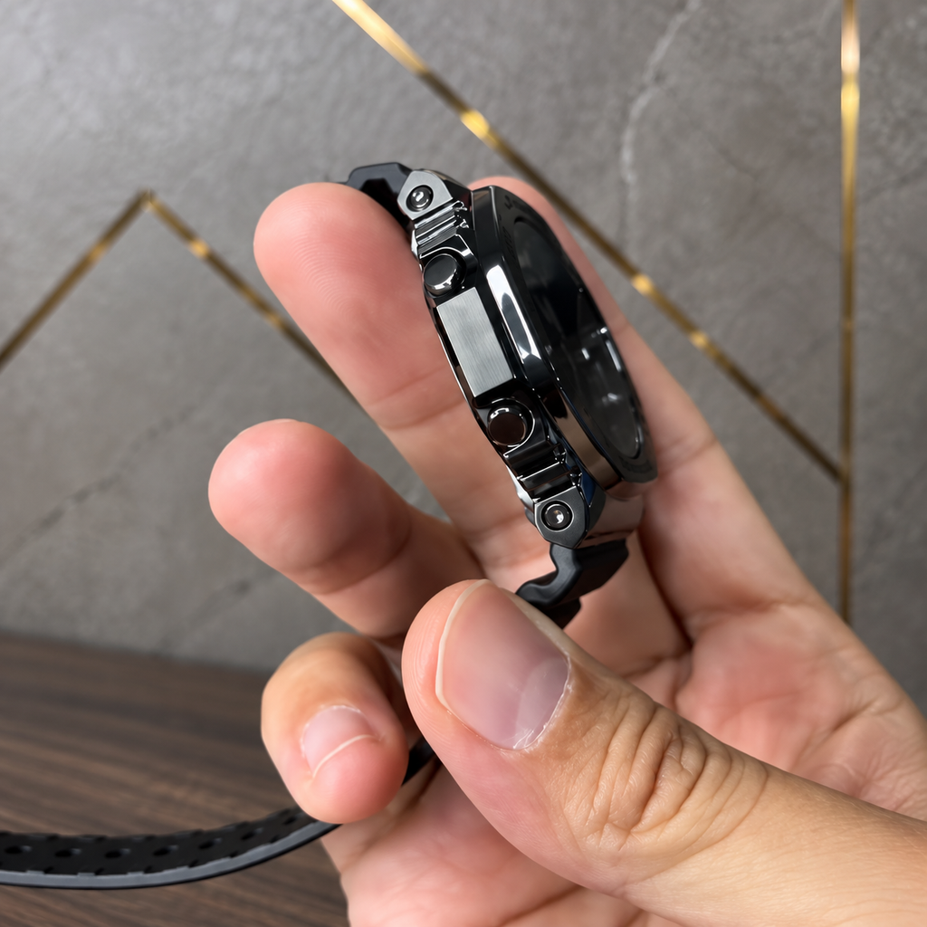 Actual watch side profile from supplied video; digitally composited against PRIMEPICKS grey-and-gold office wall