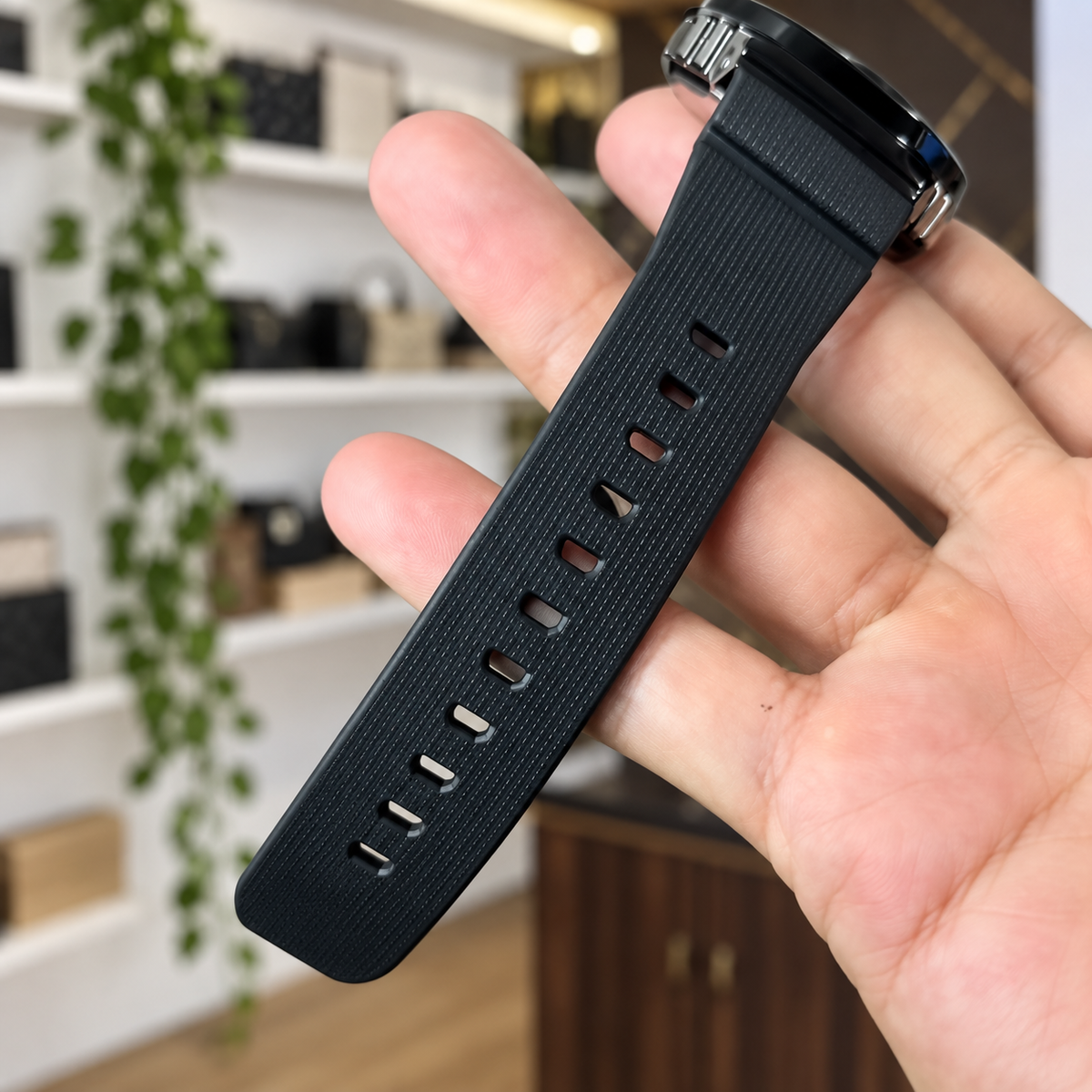 Actual black strap detail from supplied video; digitally composited against PRIMEPICKS office shelves